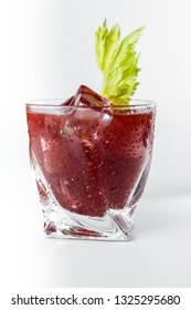 Delicious Cocktail Using Hydrated Chia Seeds And Tart Cherry Juice With Fresh Celery Served On The Rocks Over A White Background