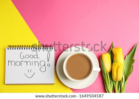 Delicious coffee, beautiful flowers and GOOD MORNING wish on color background, flat lay. Space for text