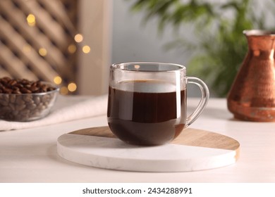 Delicious coffee in cup on white wooden table - Powered by Shutterstock