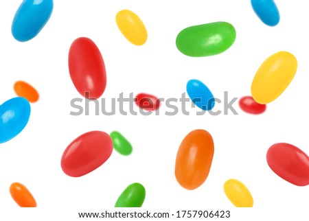 Delicious color jelly beans falling on white background