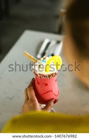 delicious colored cocktail in the hand at girl