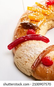 Delicious Colorful King Cake Or Rosca With Candied Fruit On A White Wooden Table. Close Up.