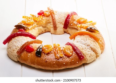 Delicious Colorful King Cake Or Rosca With Candied Fruit On A White Wooden Table.