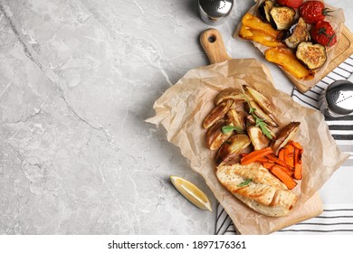 Delicious Cooked Chicken And Vegetables On Grey Marble Table, Flat Lay With Space For Text. Healthy Meals From Air Fryer