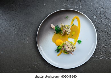 Delicious cooked rabbit, michelin star food on grey texture background