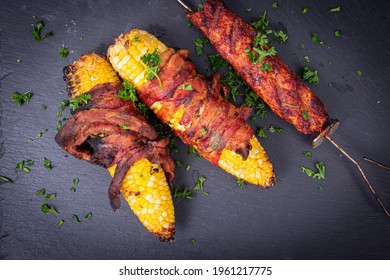 Delicious Corn On The Cob Wrapped In Bacon With Kebab Closeup