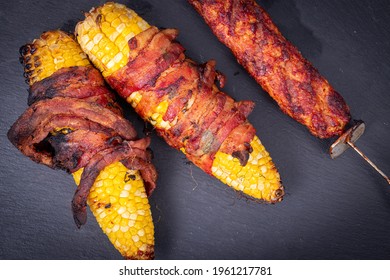 Delicious Corn On The Cob Wrapped In Bacon With Kebab Closeup