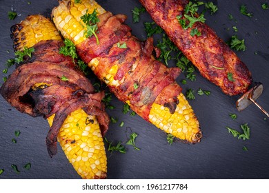 Delicious Corn On The Cob Wrapped In Bacon With Kebab Closeup