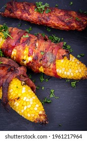 Delicious Corn On The Cob Wrapped In Bacon With Kebab Closeup