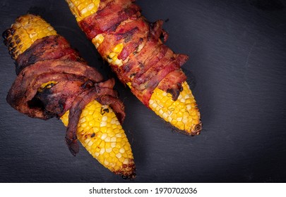 Delicious Corn On The Cob Wrapped In Bacon  Closeup