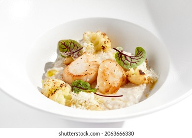 Delicious Creamy Risotto With Sea Scallop And Cauliflower. Elegant Main Course With Seafood On White Plate. Grilled Scallop With Cauliflower And Creamy Rice. Seafood Risotto With Scallops