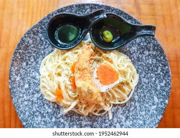 Delicious Creamy Spaghetti Pasta With Prawn Tempura And Salted Duck Egg Searved With Wasabi Shoyu Sauce. Famous Fusion Italian And Japanese Food In Thailand, Selective Focus.