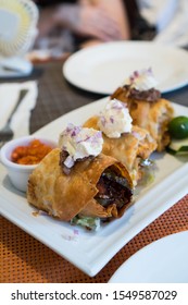 Delicious Crispy Chicken Chimichanga With Homemade Hot Sauce And Sour Cream