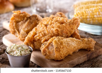 Delicious crispy fried chicken with coleslaw and corn on the cob.