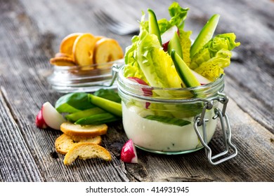 Delicious crispy salad with yoghurt sauce and crackers