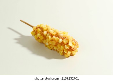 Delicious Crunchy Korean Style Chunky Potato Corn Dogs with Batter and Fried Potatoes. Isolated on Cream Background with Copy Space for Text