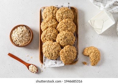 Delicious and crunchy oatmeal cookies, oatmeal flakes and a cup of milk on white background. Copy space for text. Recipe, bakery menu, healthy dessert. Top view, flat lay - Powered by Shutterstock