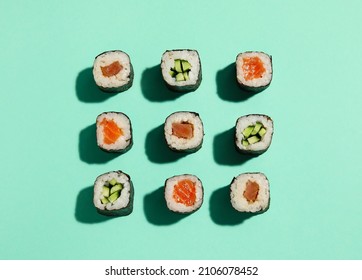 Delicious Cucumber And Salmon Maki Sushi On Color Background