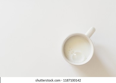 Delicious cup of milk on white with copy space. Top down view. - Shutterstock ID 1187100142