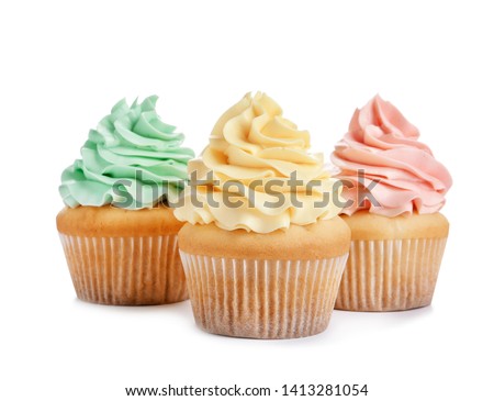Delicious cupcakes with cream on white background