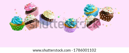 Delicious Cupcakes for party, birthday. Various cupcakes with pink white and blue cream flying over pink background