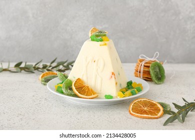 Delicious curd Easter cake with candied fruits on light background