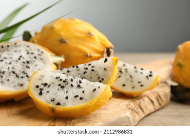 Delicious cut dragon fruit (pitahaya) on wooden board, closeup. Space for text