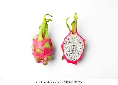 Delicious cut and whole dragon fruits (pitahaya) on white background, top view