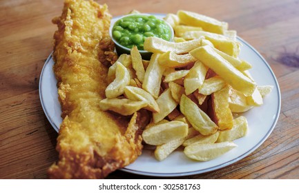 Delicious deep fried battered Cod Fish with Chips in a Fish and Chips restaurant in Greater London