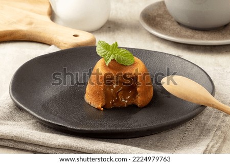 Delicious dessert petit gateau stuffed with dulce de leche in a plate