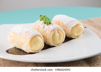 
Delicious dessert of puff pastry rolls filled with pastry cream