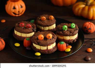 Delicious Desserts Decorated As Monsters On Wooden Table. Halloween Treat