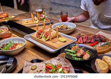 Delicious Dinner In Restaurant On A Wooden Table, No People Are Visible. Tasty Food With Beer In Cafe Or Pub Menu.