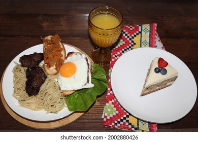 Delicious Dinner With Scrambled Eggs, Kebabs, Mushroom Sandwich, Lettuce, Spaghetti, Orange Juice And A Slice Of Delicious Blueberry And Strawberry Cake.