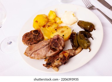 Delicious Dish Of Baked Lamb Leg With Fried Potatoes And Whole Baked Pepper