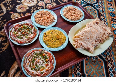 Delicious Dishes Of Traditional Omani Food Served On Carpet In Traditional Restaurant, Oman