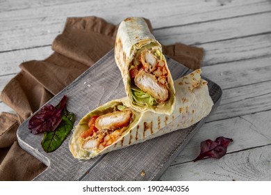 A Delicious Doner Donair Kebab Wrap With Chicken Fillet, Lettuce, Tomato,  Onion And Sauce.