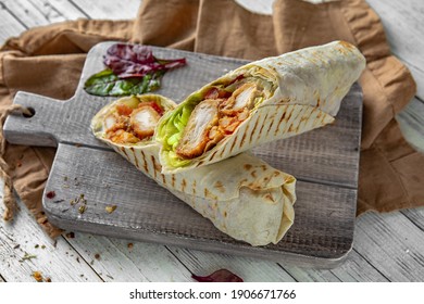 A Delicious Doner Donair Kebab Wrap With Chicken Fillet, Lettuce, Tomato,  Onion And Sauce.