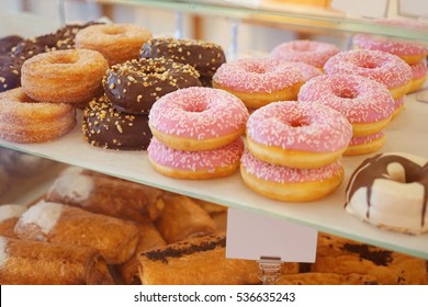 Delicious donuts on store shelves closeup