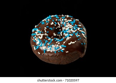 Delicious Double Chocolate Donut With Blue Sprinkles Isolated On A Black Background