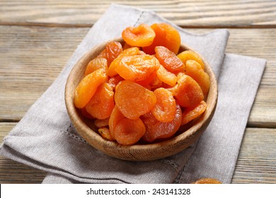 Delicious dried apricots in a bowl on napkin, food