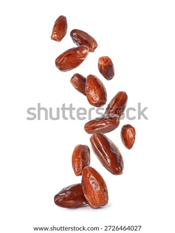 Delicious dried dates are falling down close-up isolated on a white background	