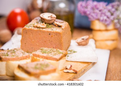 Delicious Duck Pate With Nuts And Lilac On Wooden Plate