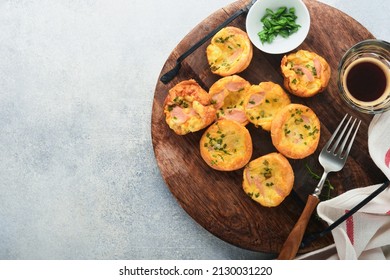 Delicious egg muffins with green onions, bacon, cheese and tomatoes on wooden board on light background. Healthy high protein and low carb breakfast. Homemade food. - Powered by Shutterstock