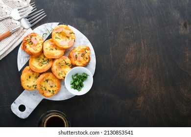 Delicious egg muffins with green onions, bacon, cheese and tomatoes on wooden board on old wooden rustic background. Healthy high protein and low carb breakfast. Homemade food. - Powered by Shutterstock