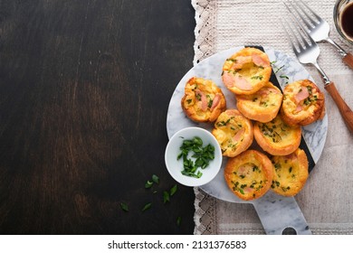 Delicious egg muffins with green onions, bacon, cheese and tomatoes on wooden board on old wooden rustic background. Healthy high protein and low carb breakfast. Homemade food. - Powered by Shutterstock