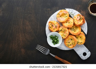 Delicious egg muffins with green onions, bacon, cheese and tomatoes on wooden board on old wooden rustic background. Healthy high protein and low carb breakfast. Homemade food. - Powered by Shutterstock