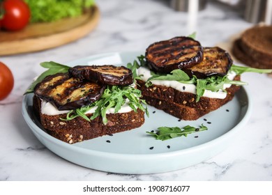 Delicious eggplant sandwiches served on white marble table