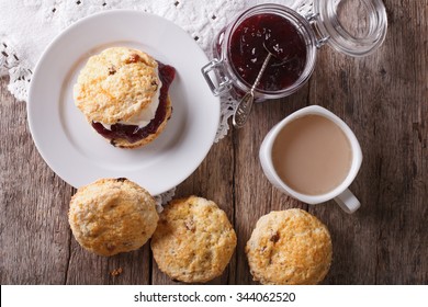 Delicious English Scones With Jam And Tea With Milk Close-up On The Table. Horizontal Top View