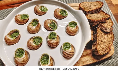 Delicious escargot served with rustic bread on a wooden platter for a cozy dining experience